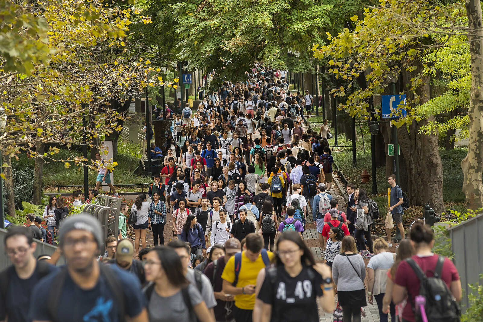 students walking on a crowded locust walk looking east